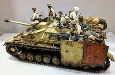 an old toy tank with soldiers on it