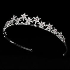 a tiara with pink and white flowers is shown on a black background in this image