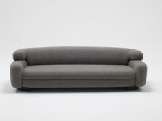 a gray couch sitting on top of a white floor