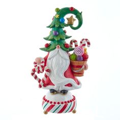 a christmas ornament with a santa clause holding a basket and candy canes