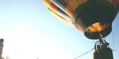 a large multicolored hot air balloon flying in the sky