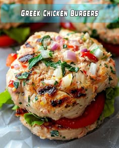 a chicken burger with lettuce and tomatoes on it