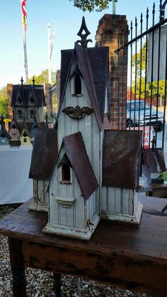 a bird house sitting on top of a wooden table