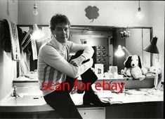 a man sitting on top of a counter in front of a mirror with the words scan for ebay