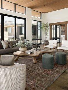 a living room filled with furniture and lots of windows