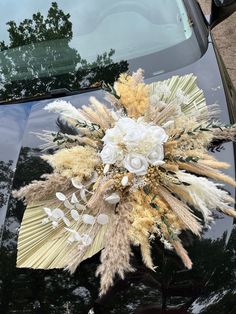 a bouquet of flowers is placed on the hood of a car