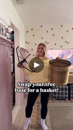 a woman standing in a room holding two buckets with the words swap your tree base for a basket