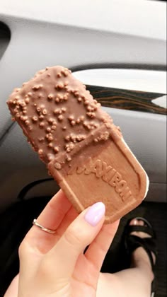 a person holding an ice cream bar in their hand