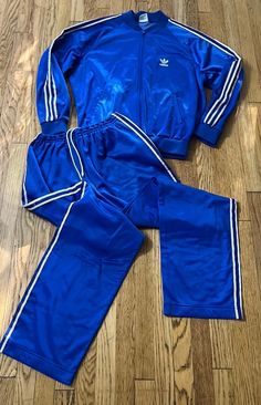 Excellent vintage condition labeled size XL Warm up top measures pit to pit 26" / pit to wrist 22"/ length (shoulder to bottom) 27" / Elastic waist pants measure waist 14"-18" comfortably / inseam 34"/ length (waist to bottom leg) 46 1/2" / smoke-free home no issues / pants have two front zippered pockets and jacket. Have two front handwarmers pockets. All ribbing has its original stretch. smoke-free environment (122) Nike 90s Vintage Track, Sports Tracksuit With Three Stripes And Long Sleeves, Blue Activewear For Jogging With Three Stripes, Blue Sportswear Tracksuit For Training, Blue Tracksuit For Training, Sportswear Style, Blue Tracksuit For Training, Blue Sporty Tracksuit For Training, Blue Casual Tracksuit For Training, 80s Adidas