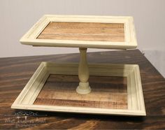 a wooden table with two small square trays on top of it and the bottom is made out of wood