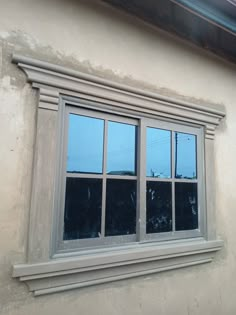 a window with three panes on the side of it