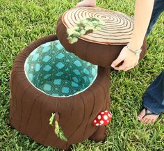 a person standing in the grass with a piece of furniture