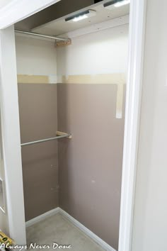 an empty closet with some paint on the walls