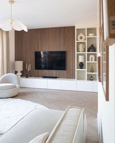 a modern living room with white furniture and wood paneling