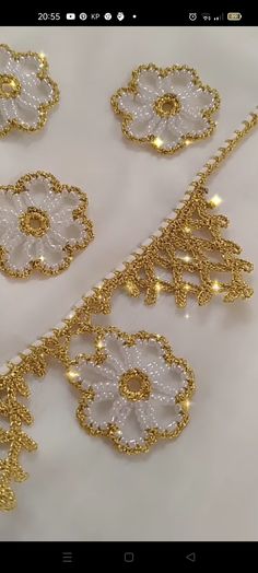 gold and white beaded lace with flowers on it