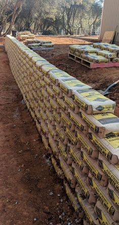 several boxes are stacked on top of each other in front of a building under construction