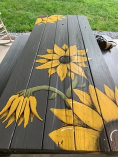 a painted wooden bench with sunflowers on it