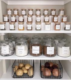 the shelves are filled with different types of spices and food in glass jars on them