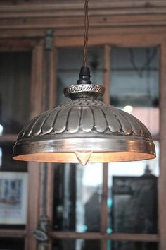 a large metal light hanging from the ceiling