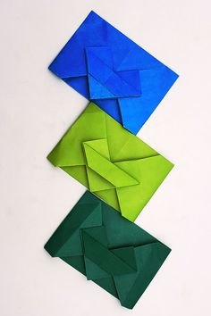 three folded origami pieces sitting on top of each other