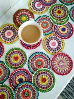 colorful crocheted coasters with a cup of coffee