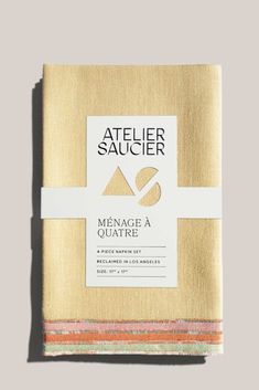 two folded napkins on top of each other with the words atelier saucier