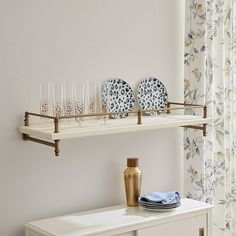 two shelves with plates and glasses on them