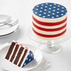 a piece of cake with an american flag frosting on it and another plate with a fork next to it