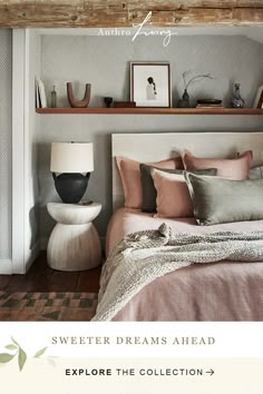 a bed sitting under a wooden beam next to a shelf filled with pictures and other items