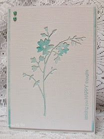 a white card with a green flower on it