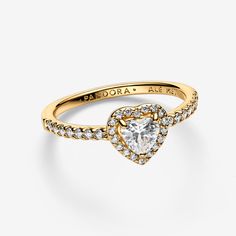 Tell the world you believe in love with our Elevated Heart Ring. A heart-shaped clear cubic zirconia sits at the centre of the ring accented by sparkling pavé in the frame of the setting and along the front of the band. - Pandora Elevated Heart Ring - 14k Gold-plated unique metal blend / Cubic Zirconia / Clear - Sz. 6 Quinceañera Rings, Pandora Elevated Heart Ring, Pandora Promise Rings, Pandora Heart Ring, Elevated Heart Ring, Promise Rings Pandora, Promise Ring Gold, Rings Pandora, Gold Promise Ring