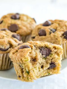 several muffins on a white plate with chocolate chips