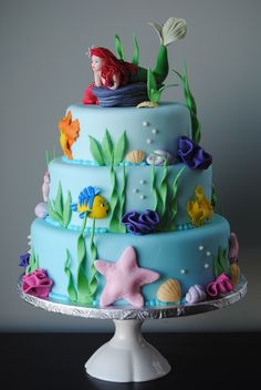 a three tiered cake decorated with under the sea theme