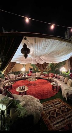 a living room filled with lots of furniture under a canopy