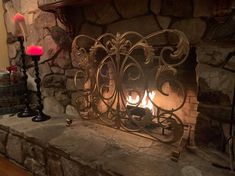 a fire place in a stone fireplace with two candles on the mantle and one lit