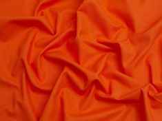 an orange fabric with very thin folds