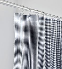 blue and white checkered curtains hanging on a metal rod