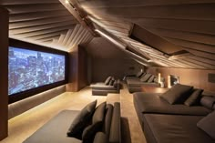 a room with couches and a large screen