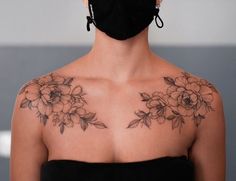 a woman wearing a face mask with flowers on her chest and shoulder tattoo design in black ink