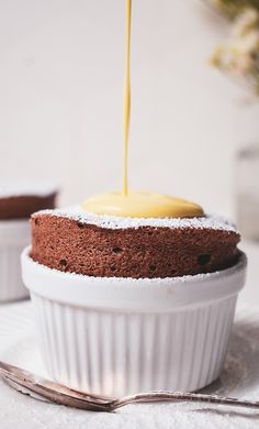 a cake is being drizzled with yellow icing on the top and bottom