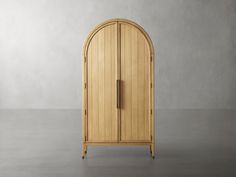 an arched wooden cabinet in the middle of a room