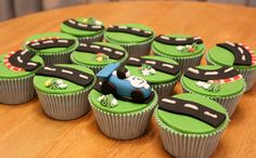 cupcakes with green frosting and black icing decorated as cars on the road