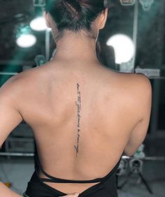 the back of a woman's neck with writing on her left shoulder and lower back