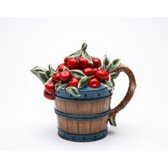 a ceramic mug with cherries in it