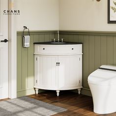 a white toilet sitting next to a sink in a bathroom under a window with green paneling