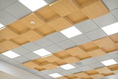 an empty room with wooden paneled ceiling and white walls