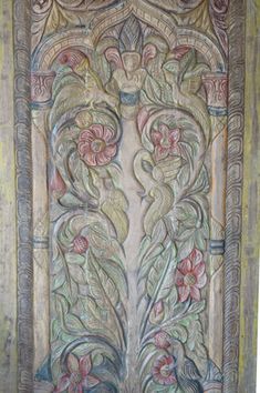 an intricately decorated door with flowers and leaves