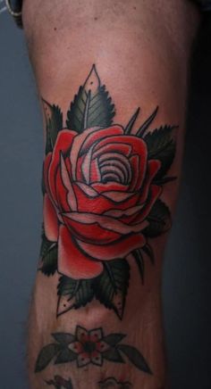 a red rose tattoo on the leg