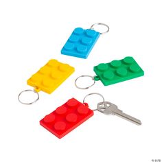 three lego keychains are shown in four different colors