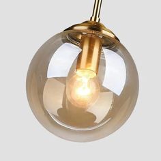 an image of a light fixture with a glass ball hanging from it's side